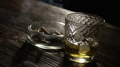 Cigarette And Glass Of Whiskey On The Table Stock Footage 71689286