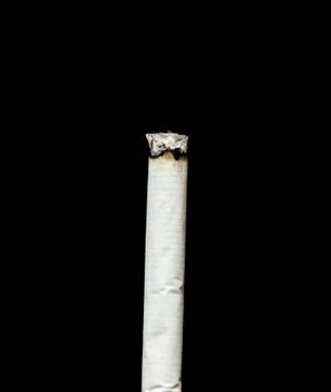 Cigarette ash on a black background Stock Photos