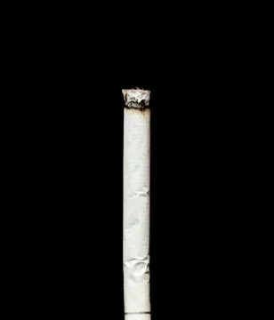 Cigarette ash on a black background Stock Photos