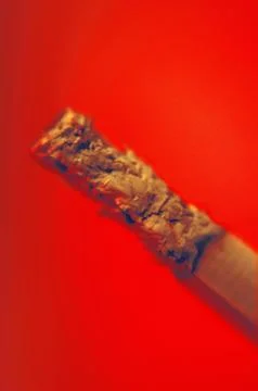 Cigarette Ash in Red Abstract Background Stock Photos