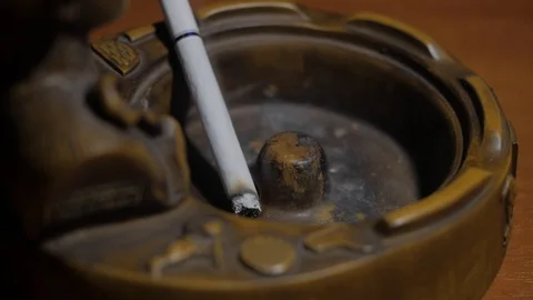 The cigarette is in the ashtray and smouldering Stock-Footage 119069089