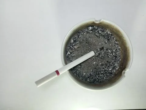 Cigarette in Ashtray with Burnt Ashes Stock Photos