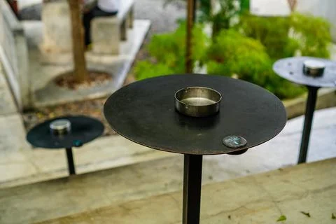 Cigarette ashtray on the cafe table Stock Photos