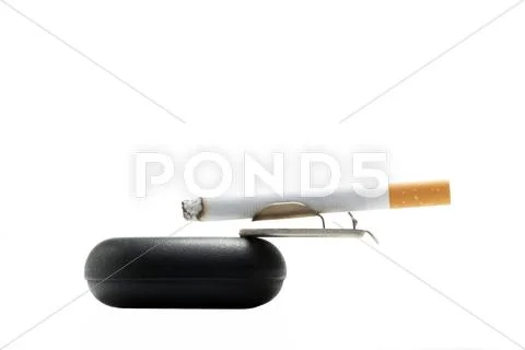 Cigarette on ashtray over white.jpg Stock Photos