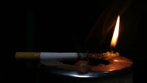 Cigarette burning and candle light Stock Footage 102452435