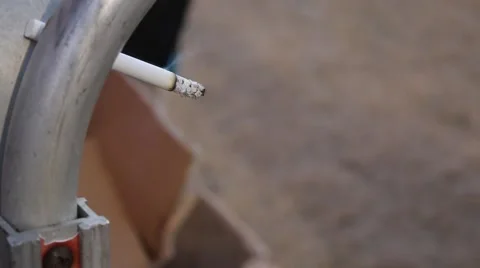 Cigarette burning and wedged in mover's handrail Stock Footage 45564550