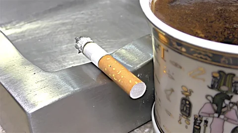 Cigarette Burning on Ashtray, Coffee Mug, Egyptian Mug -  close up, detail Stock Footage 82839434