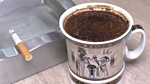 Cigarette Burning on Ashtray, Coffee Mug, Egyptian Mug -  close up, detail Stock Footage 82839457