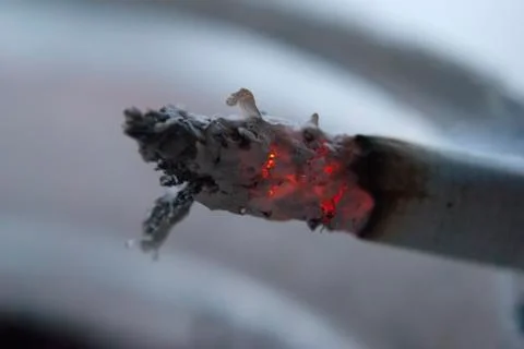 Cigarette burning closeup Stock Photos