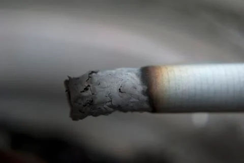 Cigarette burning closeup Stock Photos