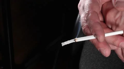 Cigarette burning in hand Stock Footage 196964571