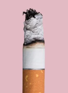 Cigarette burning on pink background Stock Photos