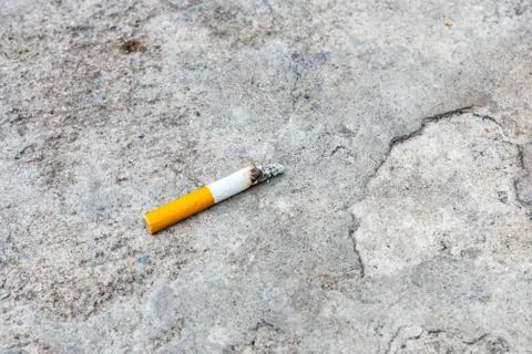 Cigarette butt on the concrete Stock Photos