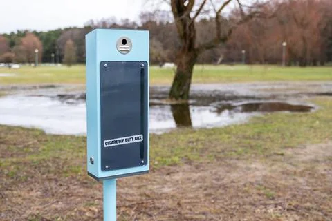 Cigarette butt disposal container in park Stock Photos