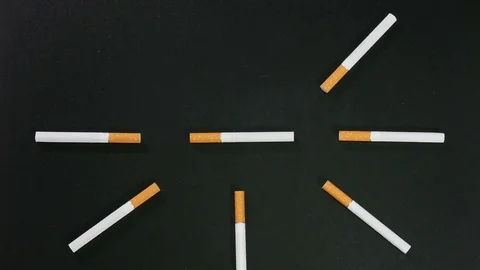 Cigarette clock on black surface Stock Footage 71228321