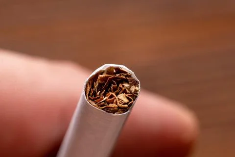 Cigarette close up on hand background. Stock Photos