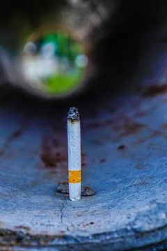 A cigarette on a concrete pipe Stock Photos