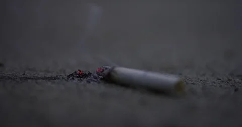 Cigarette dropped extreme closeup macro put out shoe Stock Footage 71784321