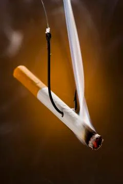 Cigarette with a fish hook through it Foto stock