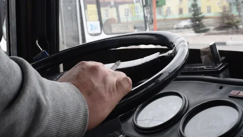 Cigarette in the hand of a man on the steering wheel of a car Stock Footage 108012308