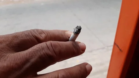 A cigarette in the hand of an old man Stock Footage 284441463