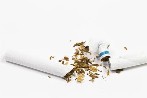 A cigarette has been broken in half Stock Photos