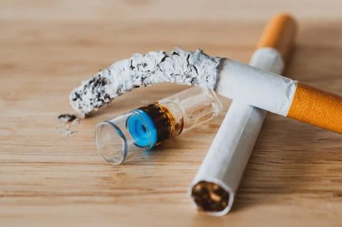 Cigarette holder filter reduce tar on wood desk. Stock Photos