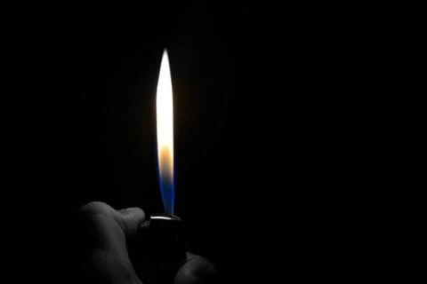 Cigarette lighter flame on a black background Stock Photos