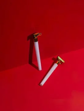Cigarette lighters on red surface with shadow effect Stock Photos