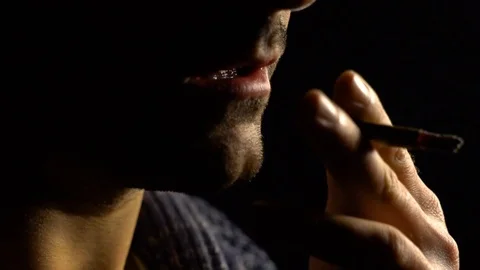 Cigarette, man with a beard, bad habits, on black background, silhouette slow Stock Footage 100708480