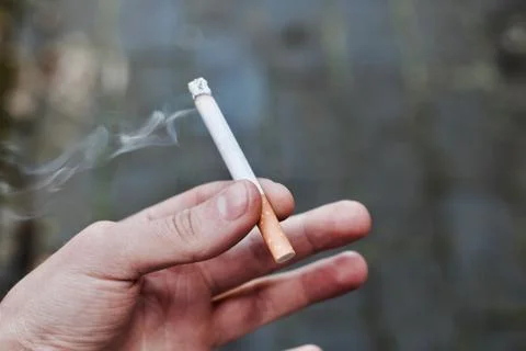 Cigarette in man hand Stock Photos