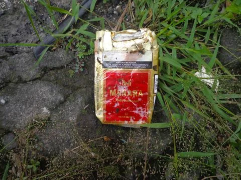 Cigarette packets on the roadside Stock Photos