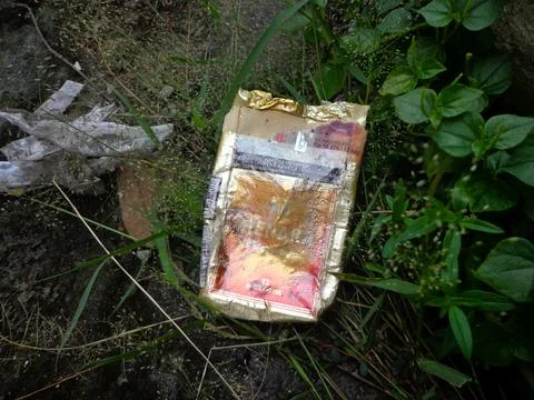 Cigarette packets on the roadside Stock Photos