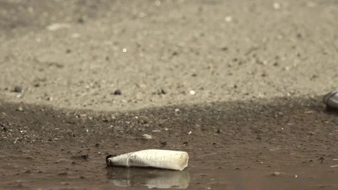 Cigarette on the pavement. Video stock 74627470