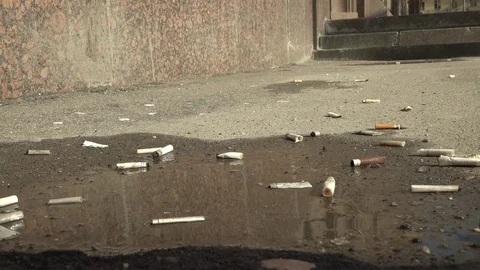 Cigarette on the pavement. Video stock 74631230