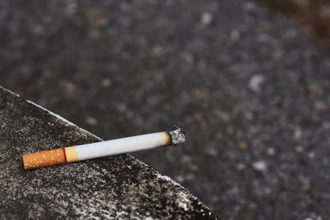The cigarette is placed on the edge of the mortar. Stock Photos