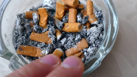 Cigarette, poor quality cigarette, butts in ash plate, Stock Footage 114520573