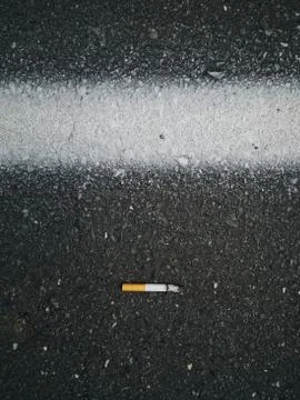 Cigarette on the road Stock Photos