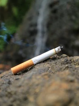 Cigarette on the rock Stock Photos