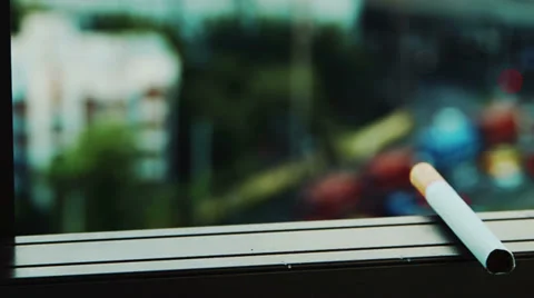 Cigarette sitting on window seal Stock Footage 39945429