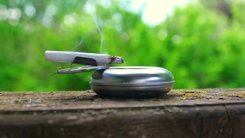 The cigarette is smoking in the ashtray Stock Footage 201213788