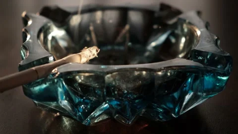 Cigarette smoldering in an ashtray close-up view Stock Footage 196473826