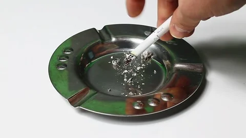 The cigarette is smoldering in the ashtray Stock Footage 151764851