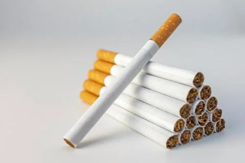 Cigarette stack in the pyramid shape. White background Stock Photos