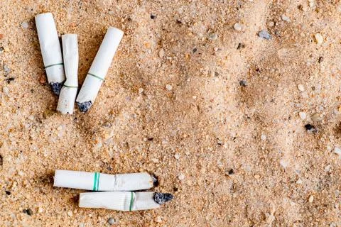 Cigarette stub in the trash Stock Photos