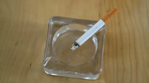 Cigarette in a transparent ash-tray Stock Footage 35155557