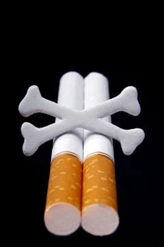 Cigarettes and scull bones Stock Photos