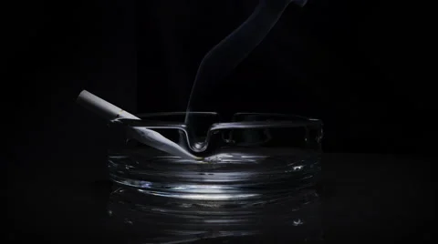 Cigarettes in an ashtray on a black background with the approach Stock Footage 43738994