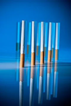 Cigarettes on bright blue background Stockfoto's
