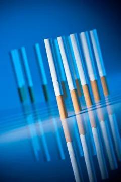 Cigarettes on bright blue background Stock-Fotos